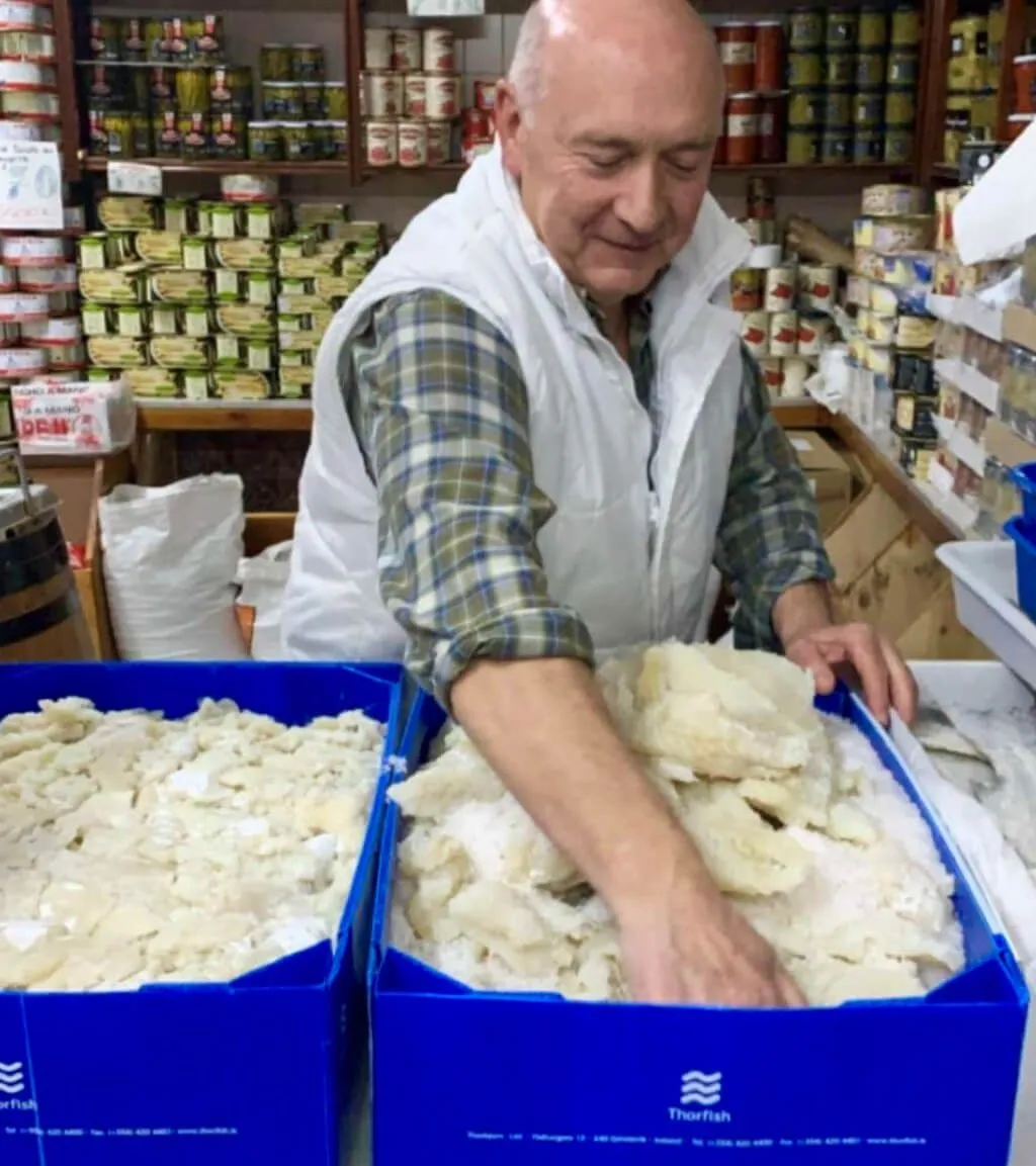 Man moving a Thorfish container filled with fish fillets